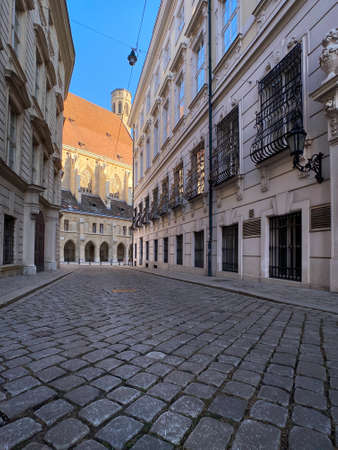 Historic Vienna, cobblestone street called Metastasiogasse with Minoritenkircheの写真素材