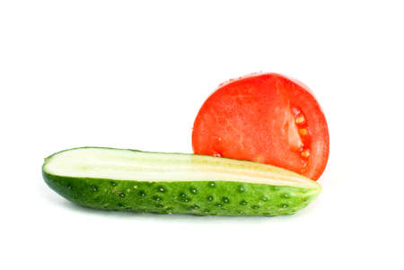 Halves of tomato and cucumber isolated on the white backgroundの写真素材