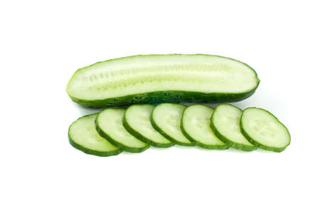 Half of cucumber and few slices isolated on the white backgroundの写真素材