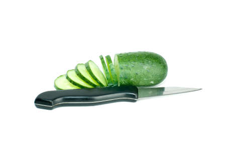 Sliced cucumber and the small steel knife isolated on the white backgrounの写真素材