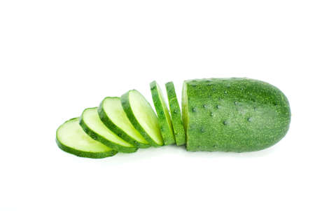Half of cucumber and few slices isolated on the white backgroundの写真素材