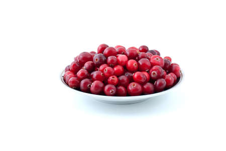 Saucer filled with ripe cranberries isolated on the white backgroundの写真素材