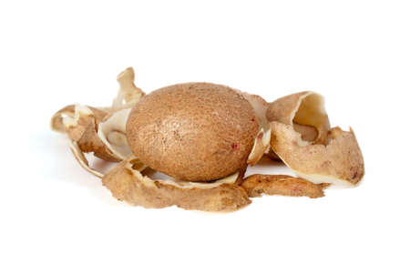 Whole potato and some peel isolated on the white background