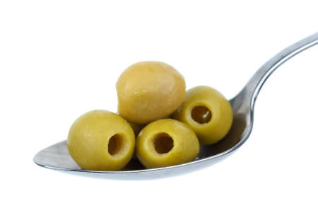Five marinated pitted green olives in the metal spoon isolated on the white backgroundの写真素材