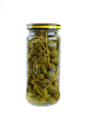 Glass jar with marinated capers fruits isolated on the white backgroundの写真素材