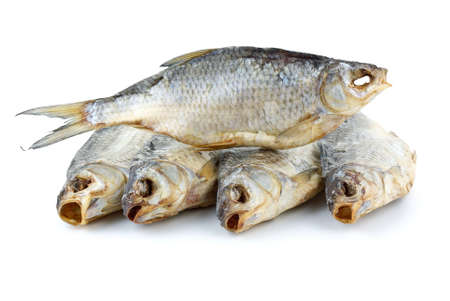 Five dried sea roach fishes isolated on the white backgroundの写真素材