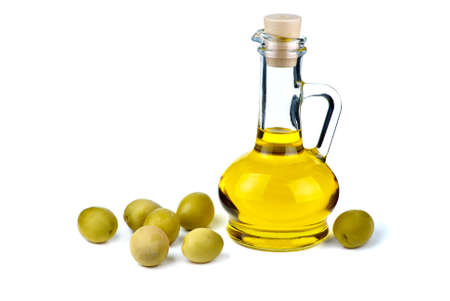 Small decanter with olive oil and some olives near isolated on the white background