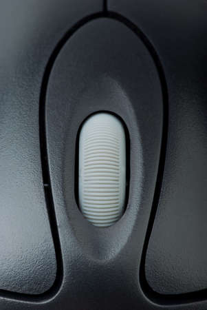 Close-up shot of computer mouse wheel and buttons. Shallow DOF. Focused on the weel