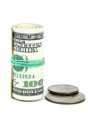 Roll of $100 banknotes tightened with rubber band and two coins isolated on the white backgroundの写真素材