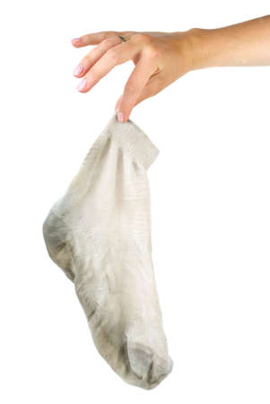 Hand holding dirty white sock isolated on the white backgroundの写真素材