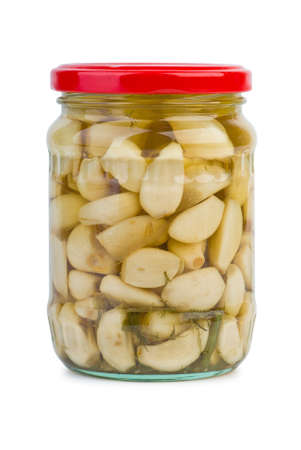 Glass jar with marinated garlic isolated on the white backgroundの写真素材