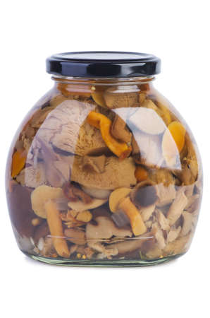 Glass jar with assorted marinated mushrooms on the white backgroundの写真素材