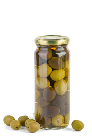 Glass jar with green and black olives   Some nearの写真素材