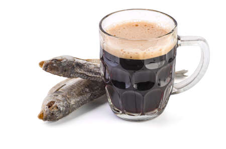 Glass mug with brown ale and dried fish on white backgroundの写真素材