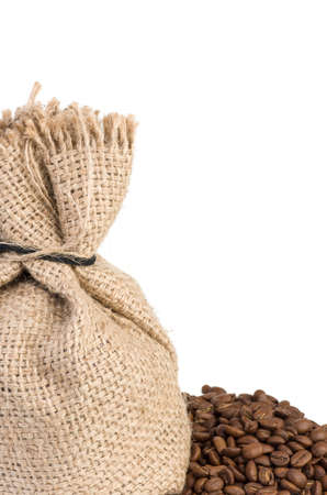 Jute bsack and coffee beans over the whiteの写真素材