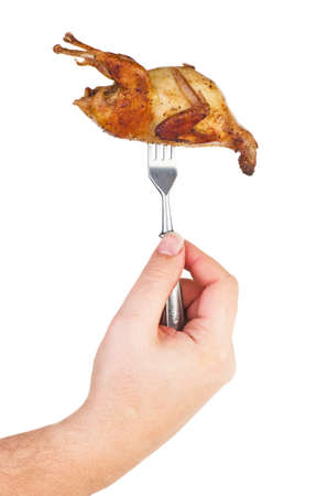 Hand hold roasted quail on forkisolated on white backgroundの写真素材