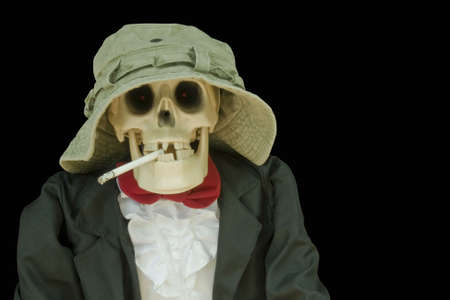 skull in hat and tie smoking a cigaretteの写真素材