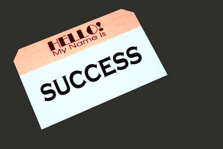 name tag with the word success printed on itの写真素材