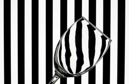 glass on striped background showing the effects of refracted lightの写真素材