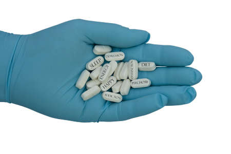a blue glove filled with pills indicating what they are for with clipping path at original size