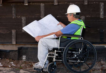 handicapped man in a wheelchair at a remodel job site