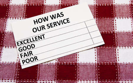 customer service survey card on a checkered tableclothの写真素材
