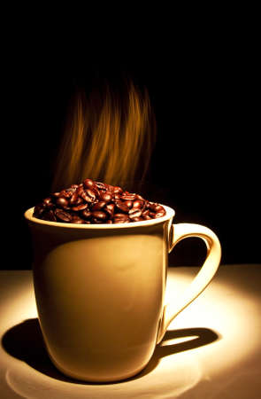 ceramic cup filled with smoking hot coffee beansの写真素材