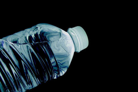 plastic bottle filled with water on a black backgroundの写真素材