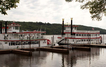 RIVER FALLS,WISCONSIN-AUGUST 21,2015: Two vintage paddle wheel boats at the docks on a river.のeditorial素材