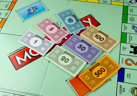 RIVER FALLS,WISCONSIN-NOVEMBER 01,2015: A Monopoly board and money. There is Twenty Thousand Five Hundred and Eighty dollars in a Monopoly game.のeditorial素材