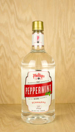 RIVER FALLS,WISCONSIN-MAY 12,2017: A bottle of Phillips brand Peppermint Schnapps with a wood background.のeditorial素材