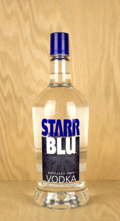 RIVER FALLS,WISCONSIN-MAY 25,2017: A bottle of Starr Blu brand vodka with a wood background.のeditorial素材