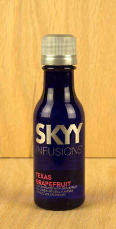 RIVER FALLS,WISCONSIN-AUGUST 04,2017: A bottle of Skyy brand grapefruit flavored vodka with a wood background.のeditorial素材