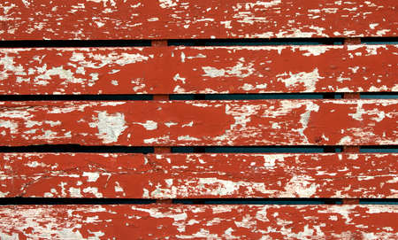 Closeup view of peeling red barnboard for background use.の写真素材