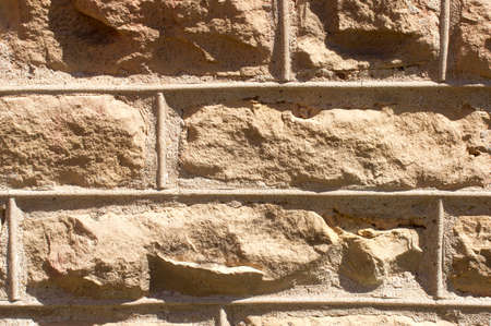 A closeup view of a stone wall for background use.の写真素材