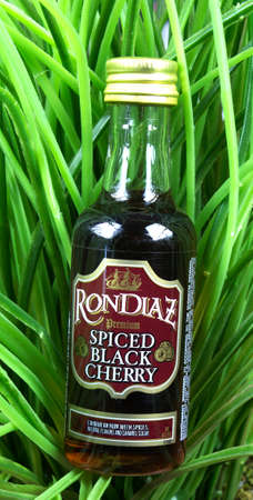 RIVER FALLS,WISCONSIN-AUGUST 14,2017: A bottle of RonDiaz brand black cherry rum against a greenery background.のeditorial素材