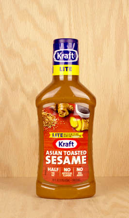 RIVER FALLS,WISCONSIN-AUGUST 03,2017: A bottle of Kraft brand Asian Toasted sesame dressing with a wood background.のeditorial素材