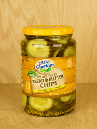 RIVER FALLS,WISCONSIN-SEPTEMBER 07,2017: A jar of Great Gherkins brand bread and butter pickles with a wood background.のeditorial素材