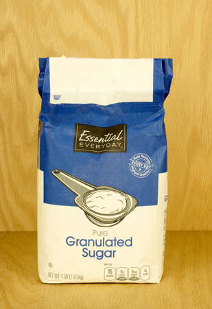 RIVER FALLS,WISCONSIN-SEPTEMBER 14,2017: A four pound bag of granulated sugar with a wood background.のeditorial素材