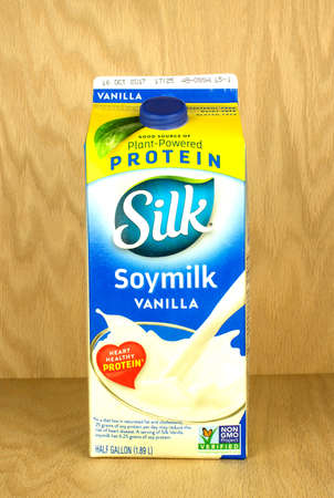 RIVER FALLS,WISCONSIN-SEPTEMBER 18,2017: A carton of Silk brand vanilla flavored soymilk with a wood background.のeditorial素材