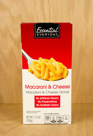 RIVER FALLS,WISCONSIN-SEPTEMBER 21,2017: A box of Essential Everyday brand cheese and macaroni with a wood background.のeditorial素材