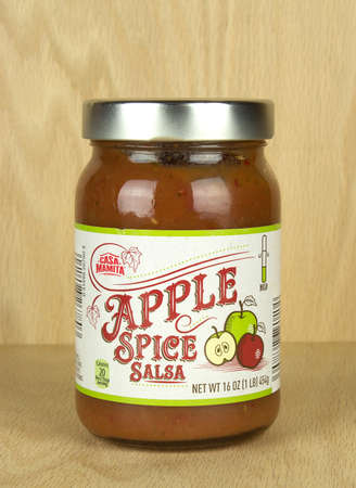 RIVER FALLS,WISCONSIN-SEPTEMBER 23,2017: A jar of Apple Spice salsa with a wood background.のeditorial素材