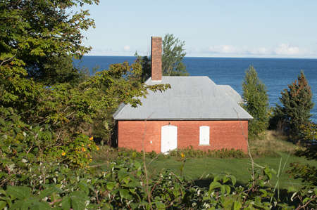 A vintage brick storage building along the shore of Lake Superiorの写真素材