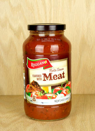 RIVER FALLS,WISCONSIN-OCTOBER 11,2017: A jar of Reggano brand pasta sauce with a wood background.のeditorial素材