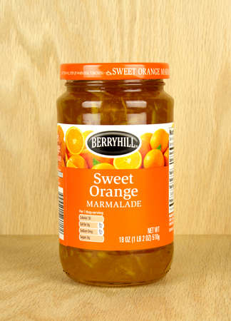 RIVER FALLS,WISCONSIN-OCTOBER 31,2017: A jar of Berryhill brand orange marmalade with a wood background.のeditorial素材