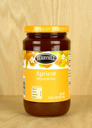 RIVER FALLS,WISCONSIN-NOVEMBER 03,2017: A jar of Berryhill brand Apricot preserves with a wood background.のeditorial素材