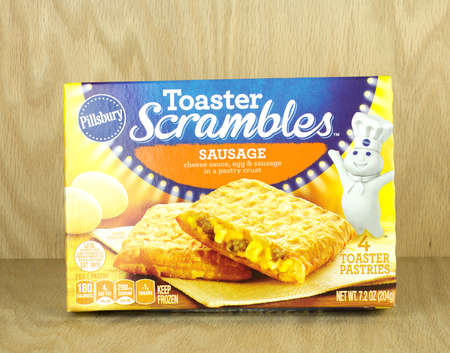 RIVER FALLS,WISCONSIN-NOVEMBER 10,2017: A box of Pillsbury brand sausage and egg toaster scramblers on a wood background.のeditorial素材