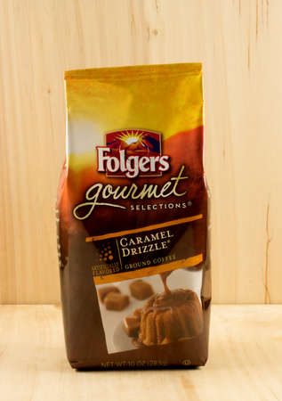 RIVER FALLS,WISCONSIN-NOVEMBER 15,2017: A bag of Folgers brand caramel drizzle ground coffee with a wood background.のeditorial素材