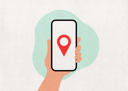 GPS - hand holding a phone on a mint paper background