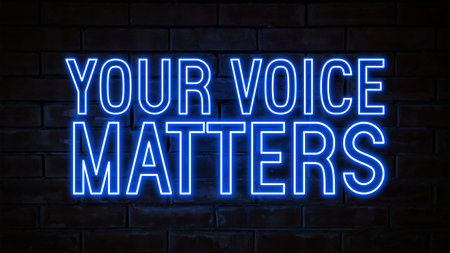 Your voice matters - blue neon light word on brick wall backgroundの写真素材